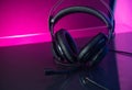 Gamer Headphones Dark Background and colorful pink Light.