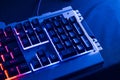 Gamer keyboard with blue backlight and red background light, modern laptop computer. Royalty Free Stock Photo