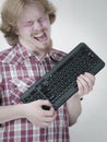 Gamer man holding computer keyboard Royalty Free Stock Photo