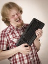 Gamer man holding computer keyboard Royalty Free Stock Photo