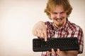 Gamer man holding computer keyboard Royalty Free Stock Photo