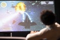 Gamer playing classic arcade action videogame on ultrawide smart TV