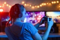 A gamer or a streamer girl at home in a dark room with a gamepad playing with friends on the networks in video games. A young man Royalty Free Stock Photo