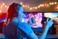 A gamer or a streamer girl at home in a dark room with a gamepad playing with friends on the networks in video games. A young man Royalty Free Stock Photo