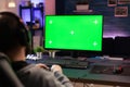Gamer using horizontal green screen on computer