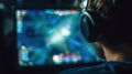 Esports Gamer Focused on Betting Interface During an Intense Gaming Session at Night in a Dimly Lit Room Royalty Free Stock Photo