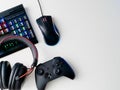 Gamer workspace concept, top view a gaming gear, mouse, keyboard, joystick, headset and mouse pad on white table background. Royalty Free Stock Photo