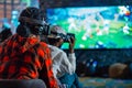 Gamers Enjoying VR Football Game. Created with Generative AI