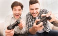 Gamers. Happy guys playing video games at home Royalty Free Stock Photo