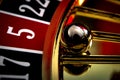 Games of chance, nightlife and casino gambling concept with a macro close up on the roulette ball in the wheel that indicates five