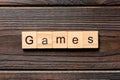 Games word written on wood block. games text on table, concept