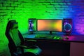 gaming chair colorful bright rgb pc keyboard mouse monitor green screen copy space front led light brick stone wall computer Royalty Free Stock Photo