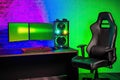 gaming chair colorful bright rgb pc keyboard mouse monitor green screen copy space front led light brick stone wall computer Royalty Free Stock Photo