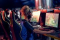 Team of professional gamers participating in global eSport tournament, side view. Mixed race teenage girl wearing Royalty Free Stock Photo