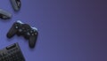 Gaming composition with joypad, keyboard and headphones with copy space on purple surface