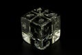 A gaming dice made of glass on a black background, to accentuate transparency.