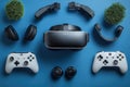 Gaming equipment arranged on a blue surface includes controllers, headset, and virtual reality gear for immersive experience Royalty Free Stock Photo