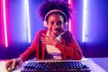 Gaming streamer, African girl playing online fighting with Esport. Tastemaker.