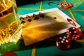 Gaming table in casino with glass of whiskey and set of four aces. Close up of a dark gambling poker table with booze Royalty Free Stock Photo