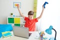 Boy with gamepad playing video game on laptop Royalty Free Stock Photo