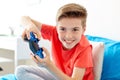 Happy boy with gamepad playing video game at home Royalty Free Stock Photo