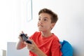 Happy boy with gamepad playing video game at home Royalty Free Stock Photo