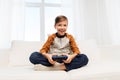 Happy boy with gamepad playing video game at home Royalty Free Stock Photo