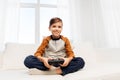 Happy boy with gamepad playing video game at home Royalty Free Stock Photo