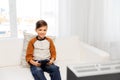 Happy boy with gamepad playing video game at home Royalty Free Stock Photo