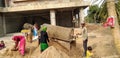 GANDHINAGAR, INDIA - DECEMBER 29, 2019: Construction workers are sieving the sand by use of sand sieving machine at some project. Royalty Free Stock Photo