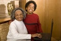 Gandmother and grandson typing on a laptop in her home.