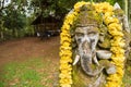 Ganesha coverd by moss in the park.Thailand