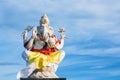 Ganesha sitting in meditating yoga pose in hindu temple