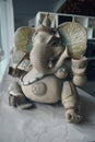 Ganesha statue holding a cup in the museum.