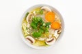 Gang Jued Woonsen is a Thai glass or bean thread noodle soup with small meatball served in white bowl on white background.