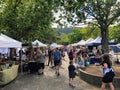 A crowd of people enjoying the saturday afternoon street market on a beautiful summer day in Ganges, Saltspring Island, Canada