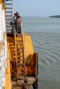 Ganges Delta, Bangladesh: Passengers on the `Rocket` paddle steamer standing above the cover of the paddle