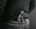 Gangster concealing his gun behind his back. back and white photo. Royalty Free Stock Photo