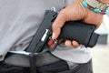 Gangster concealing his gun behind his back Royalty Free Stock Photo