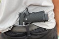 Gangster concealing his gun behind his back Royalty Free Stock Photo