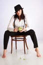 Gangster-girl sitting on chair Royalty Free Stock Photo