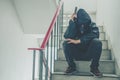 Gangster sitting on stairs, alone with his thoughts and his guns Royalty Free Stock Photo