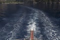 Gangway and trail at sea from a yacht, blue sea, away - rocks Royalty Free Stock Photo