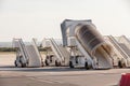 Gangways of airplan at the airport. Passenger`s boarding ramps. Passenger`s ladders. Traveling and waiting for flight at the Royalty Free Stock Photo