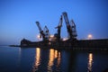 Ganrty cranes in the sea port on the coast of the Azov Sea at susnset