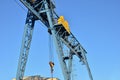 Gantry crane with hook for lifting and moving heavy cruz. Construction site. Royalty Free Stock Photo