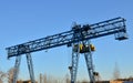 Gantry crane with hook for lifting and moving heavy cruz. Construction site. Royalty Free Stock Photo