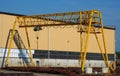 Gantry crane and its shadow on the factory wall. Royalty Free Stock Photo
