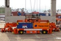 Gantry crane operator placing shipping containers on a automated transport vehicle in the Port of Rotterdam, The Netherlands,