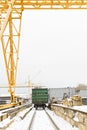 Gantry crane over railway carriage in outdoor warehouse Royalty Free Stock Photo